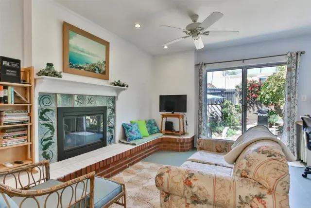 a living room with furniture a fireplace and a flat screen tv