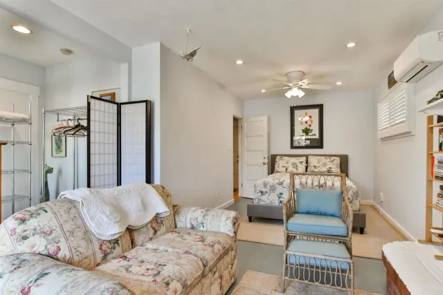 a bedroom with furniture and a chandelier