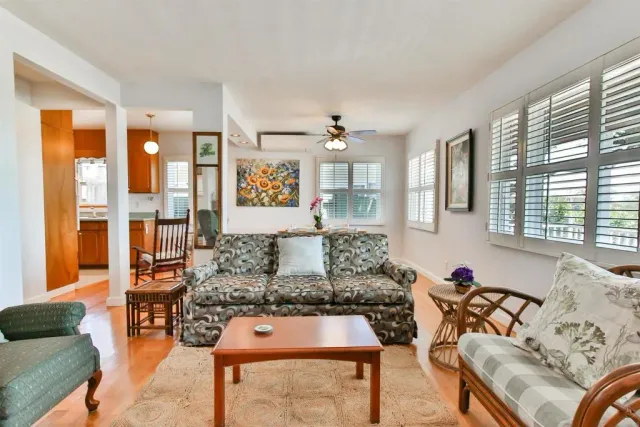 a living room with furniture and floor to ceiling windows