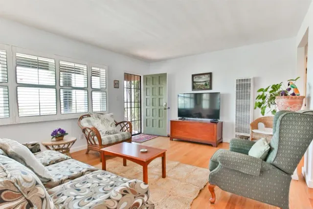 a bedroom with furniture and a large window