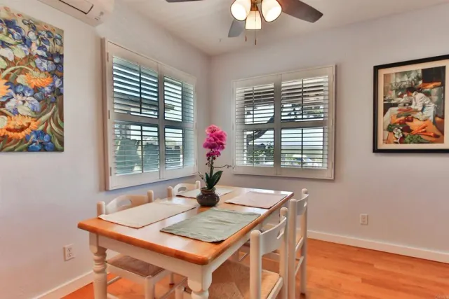 a view of a dining room with furniture wooden floor and chandelier