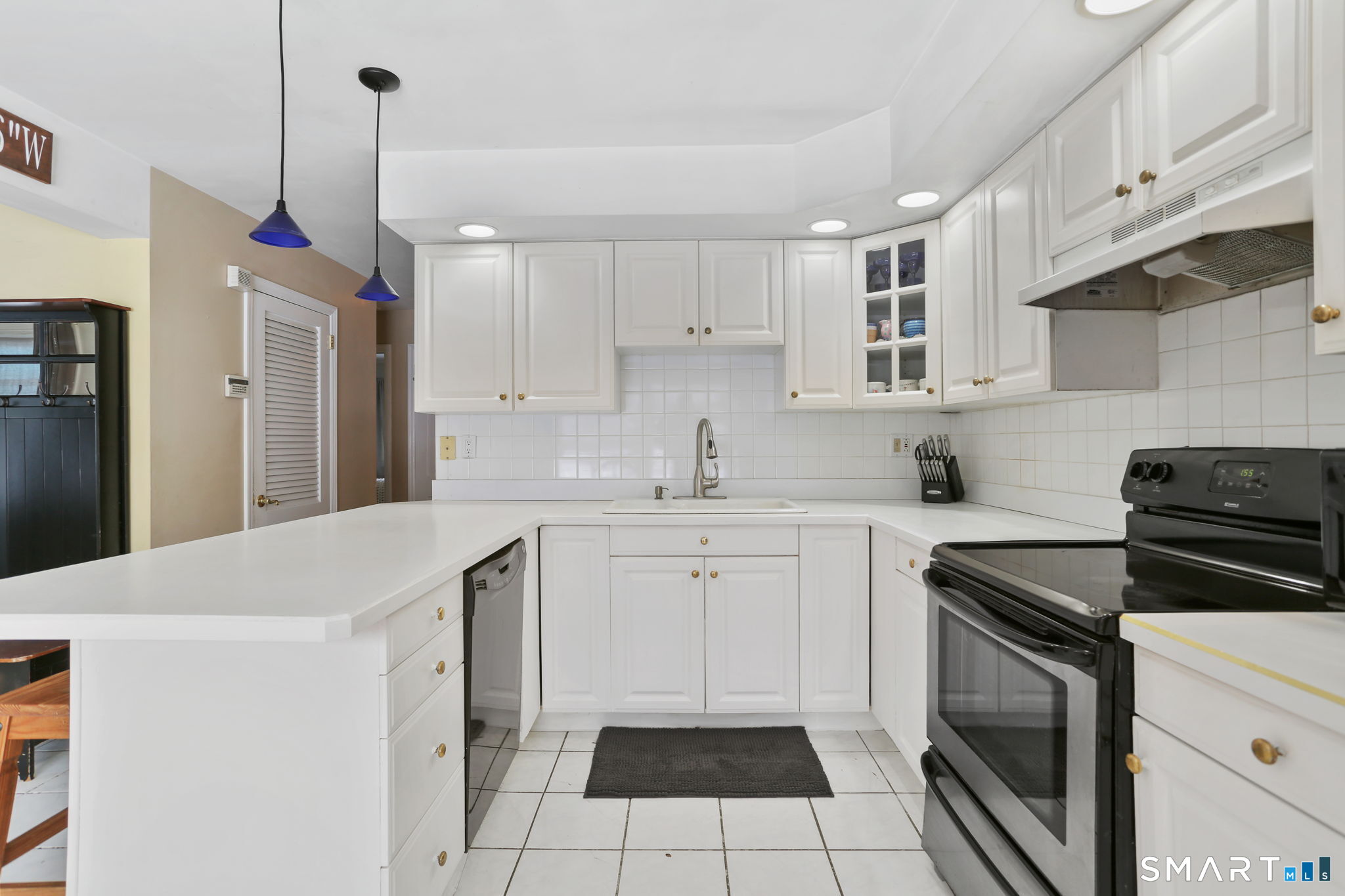 40 Rose Terrace Trumbull, CT 06611 - Photo 3 of 24 a kitchen with a sink stove and white cabinets