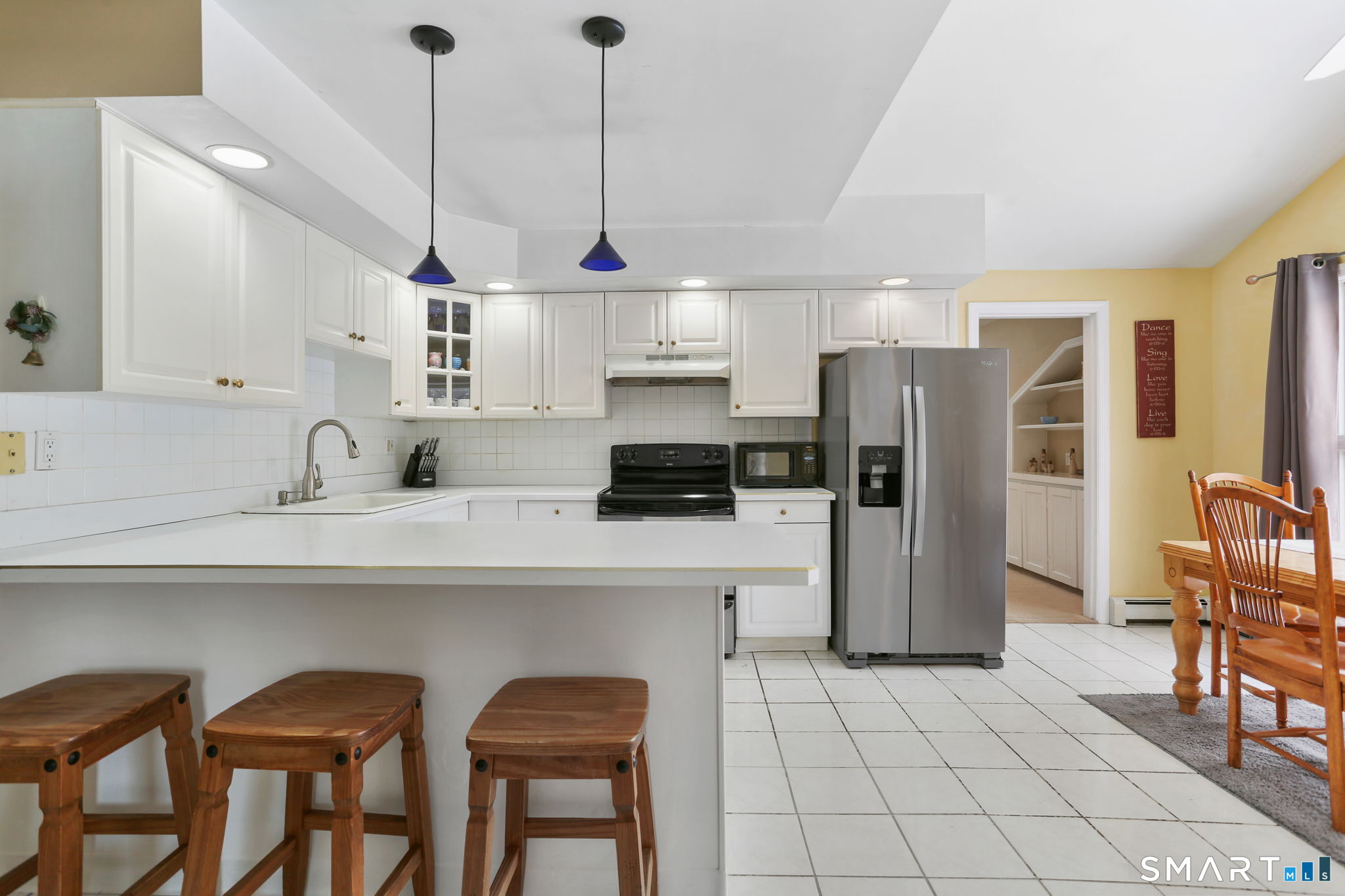 40 Rose Terrace Trumbull, CT 06611 - Photo 7 of 24 a kitchen with stainless steel appliances a refrigerator a sink a stove a table and chairs