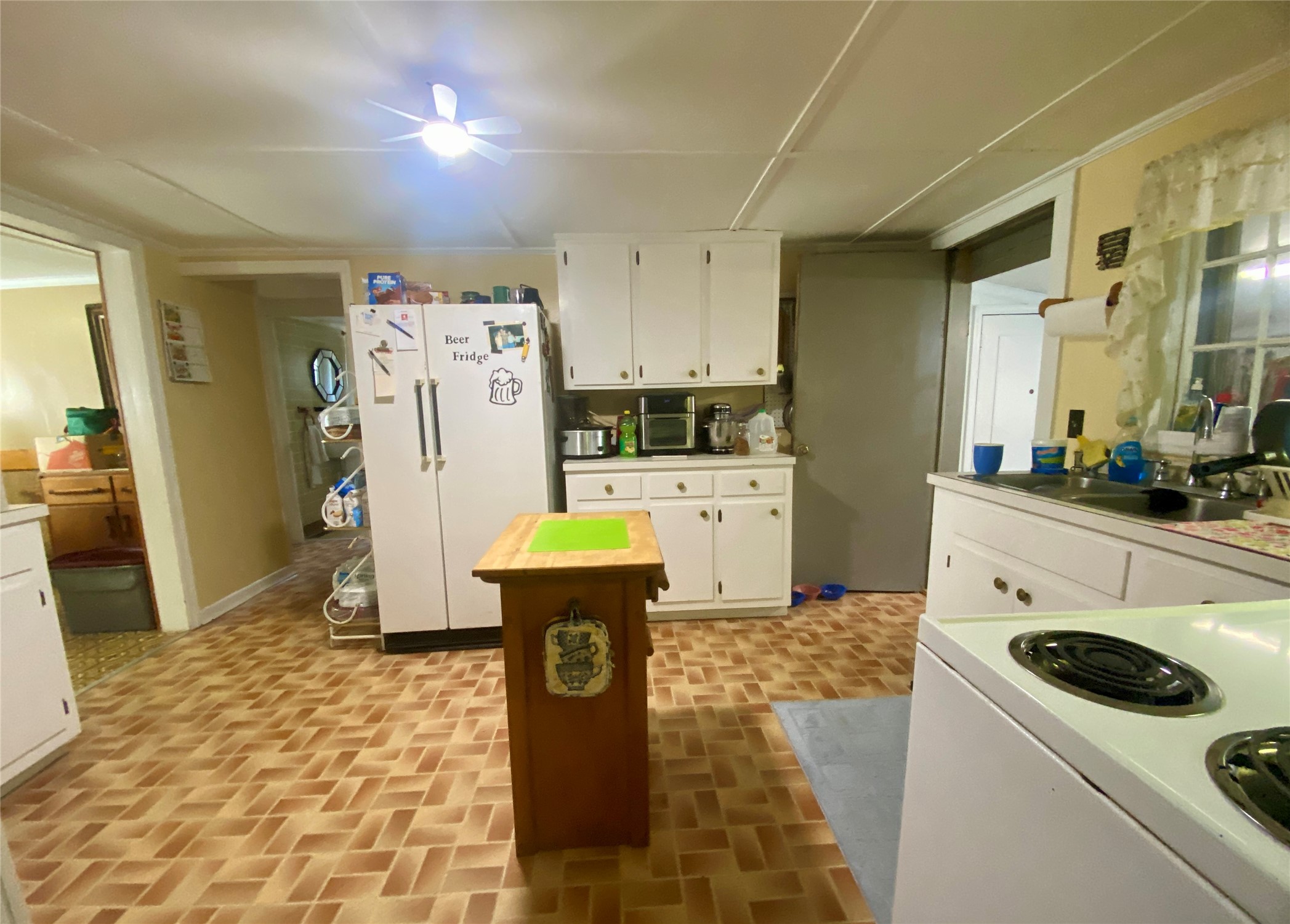 1135 Beaver Dam Road Washington, GA 30673 - Photo 14 of 42 a kitchen with refrigerator and cabinets