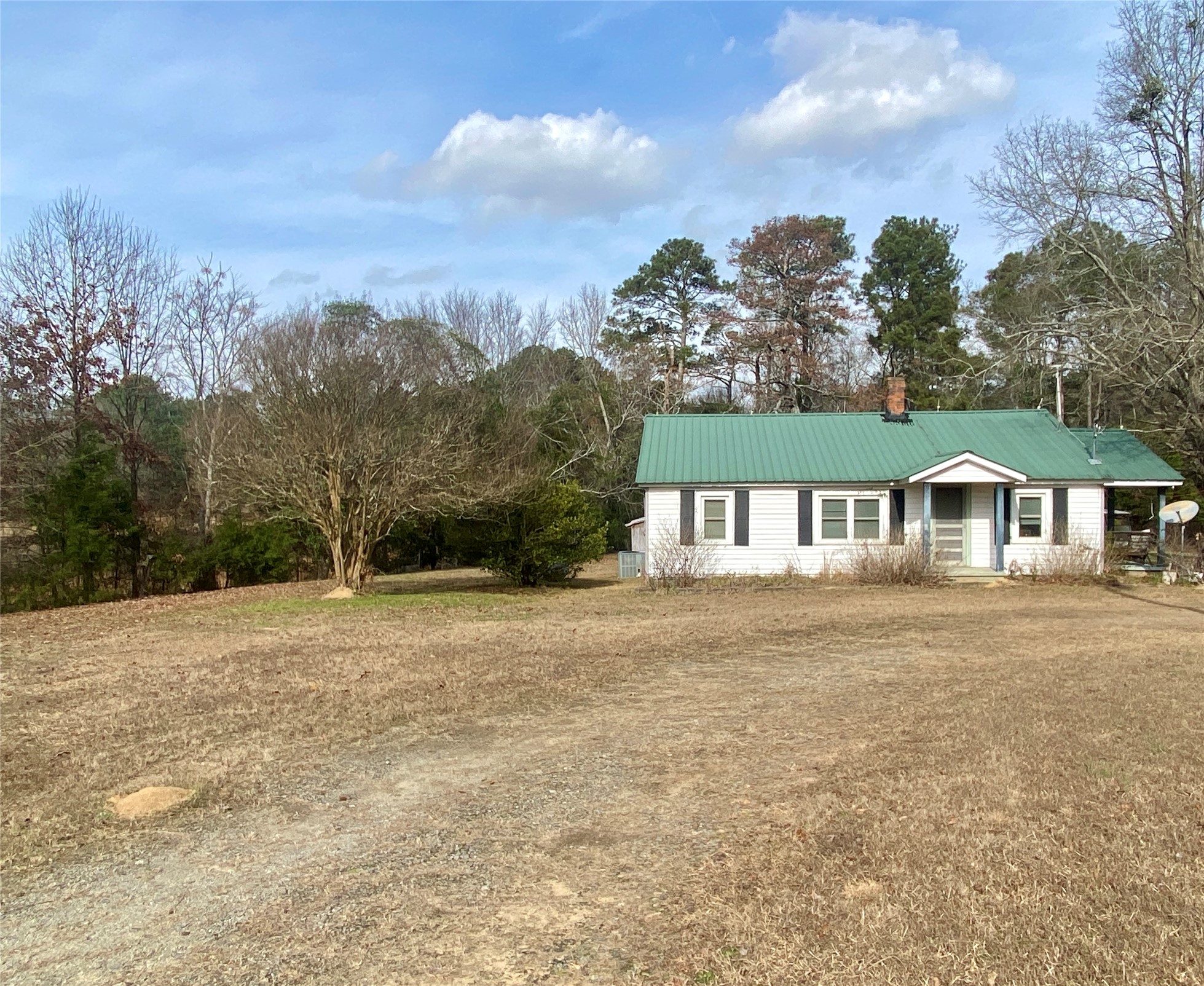 1135 Beaver Dam Road Washington, GA 30673 - Photo 2 of 42 a front view of a house with a yard and mountain view in back