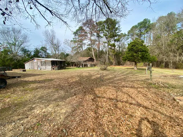 a view of a yard with large trees