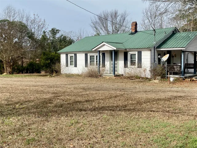 a view of a patio with table and chairs potted plants with wooden floor