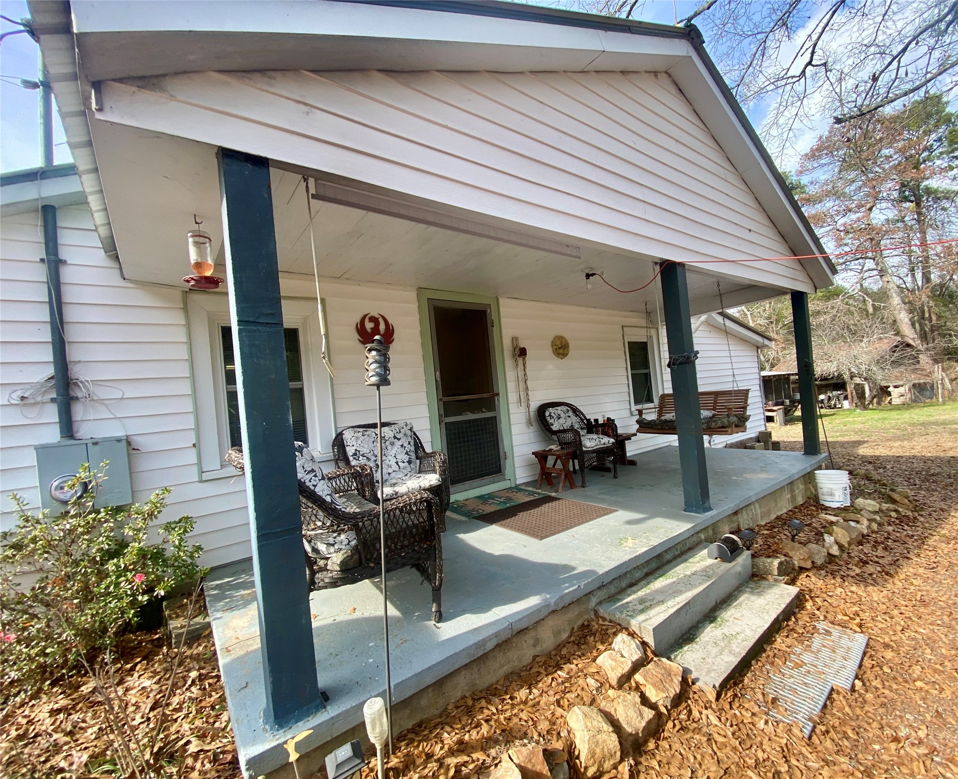 1135 Beaver Dam Road Washington, GA 30673 - Photo 5 of 42 a view of a patio with table and chairs potted plants with wooden floor