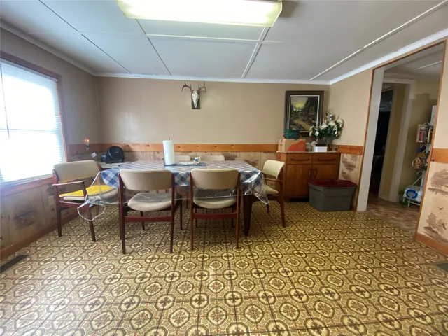 a dining room with furniture and window