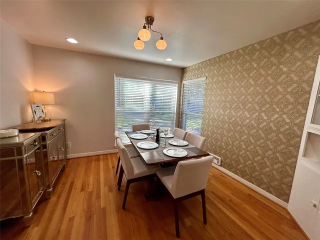 a view of a dining room with furniture window and wooden floor