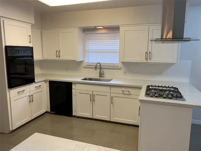 a kitchen with a refrigerator stove and sink
