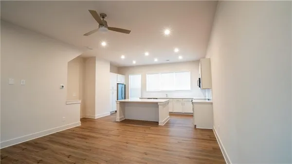 a view of a kitchen with a sink and wooden floor