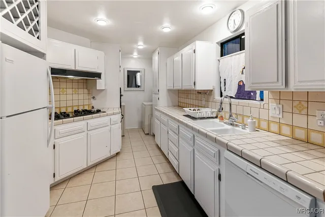 a kitchen with stainless steel appliances kitchen island granite countertop a sink and cabinets