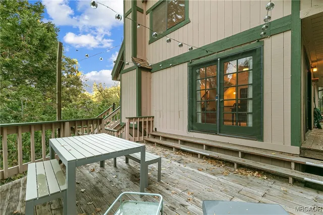 a view of backyard with a deck and furniture