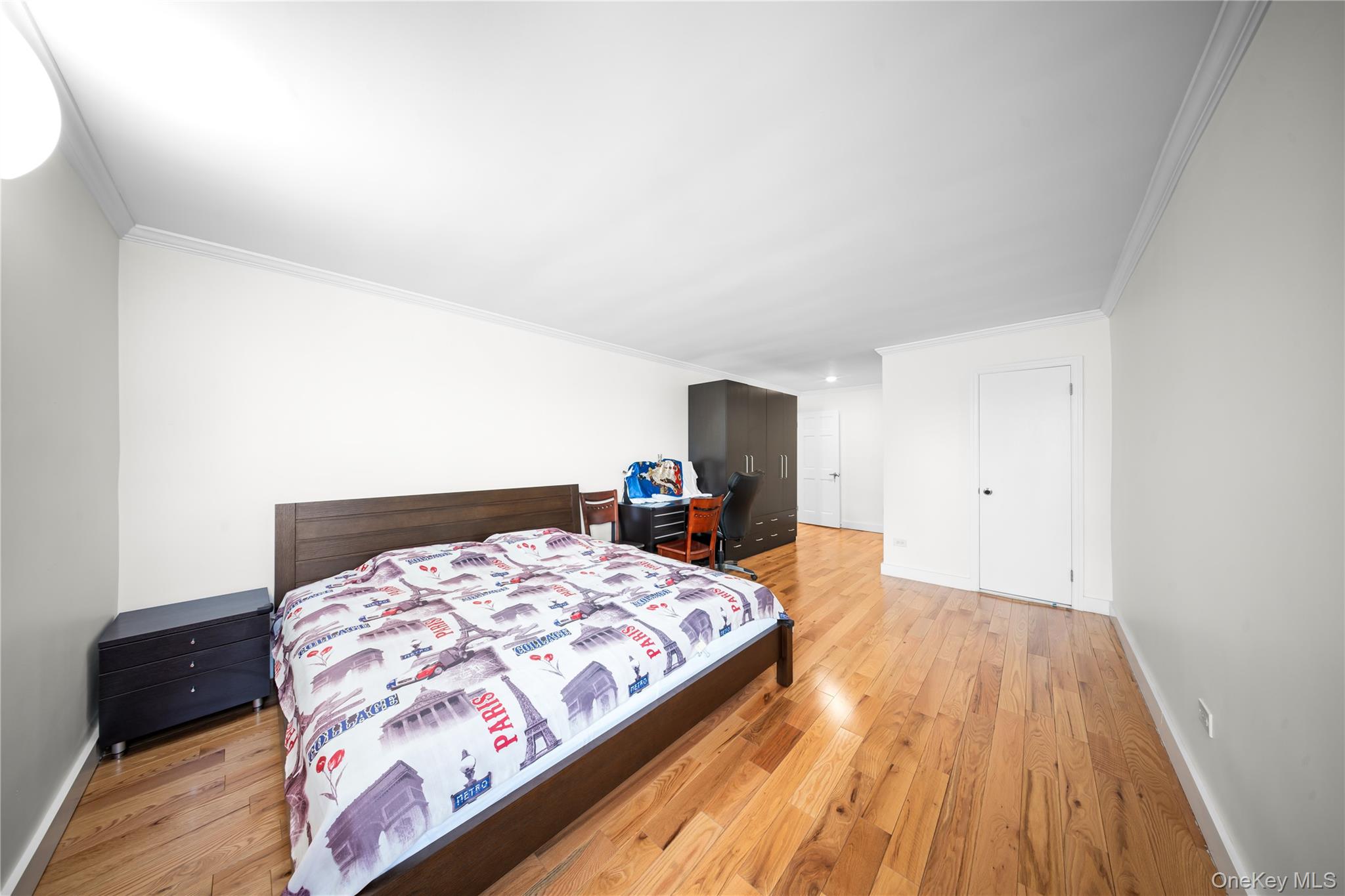 134-54 Maple Avenue, Unit 3W Queens, NY 11355 - Photo 15 of 19 Bedroom featuring crown molding and light wood-style flooring