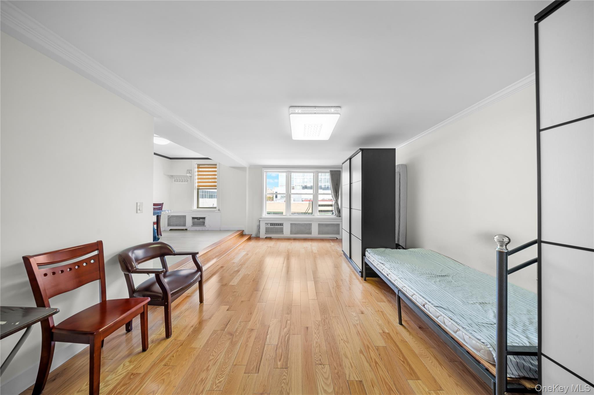 134-54 Maple Avenue, Unit 3W Queens, NY 11355 - Photo 5 of 19 Bedroom with light wood-style flooring and crown molding