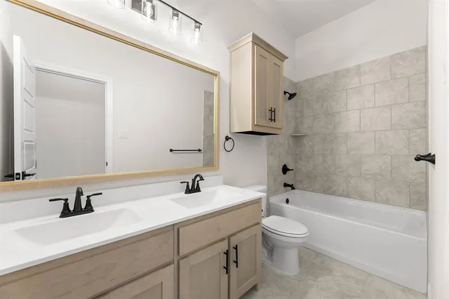 a bathroom with a toilet a sink a bathtub and mirror
