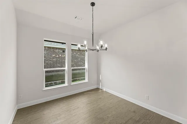 a view of a room with windows and ceiling fan