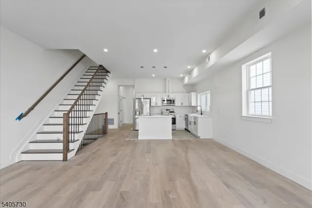 a view of kitchen with furniture and wooden floor