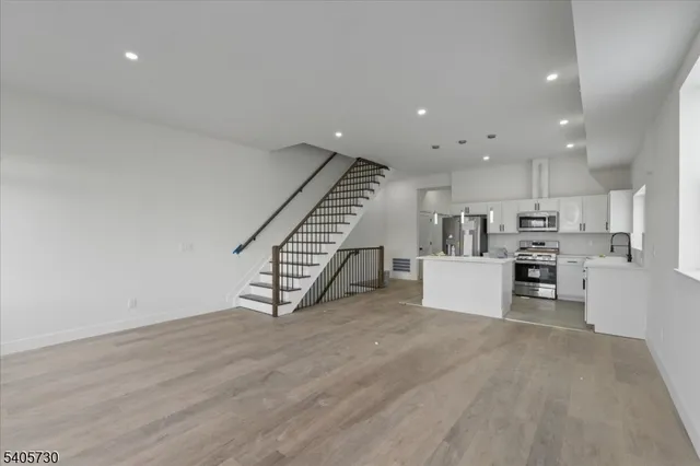 a view of kitchen with furniture and a refrigerator