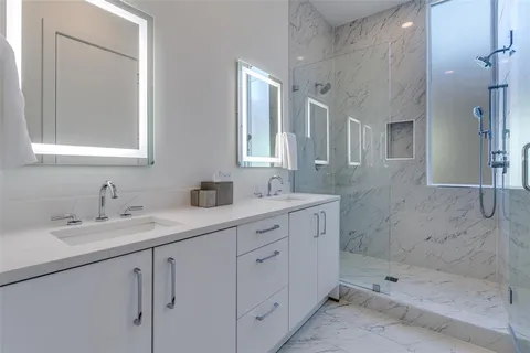 a bathroom with a shower sink and mirror