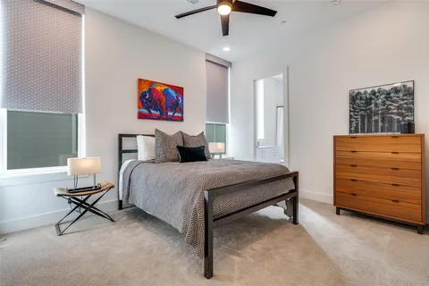 a bedroom with a bed and a desk