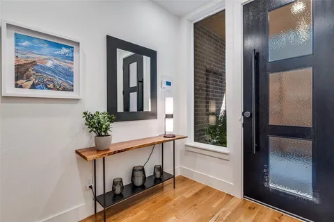 a room with painting on the wall and a potted plant