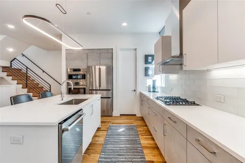 a kitchen with stainless steel appliances granite countertop a sink and cabinets