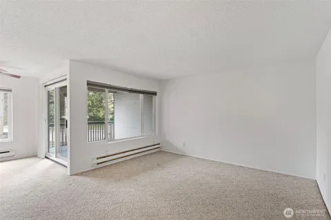 an empty room with floor to ceiling window