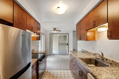 a kitchen with a sink stove and refrigerator