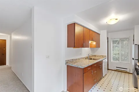 a kitchen that has a sink and a stove in it