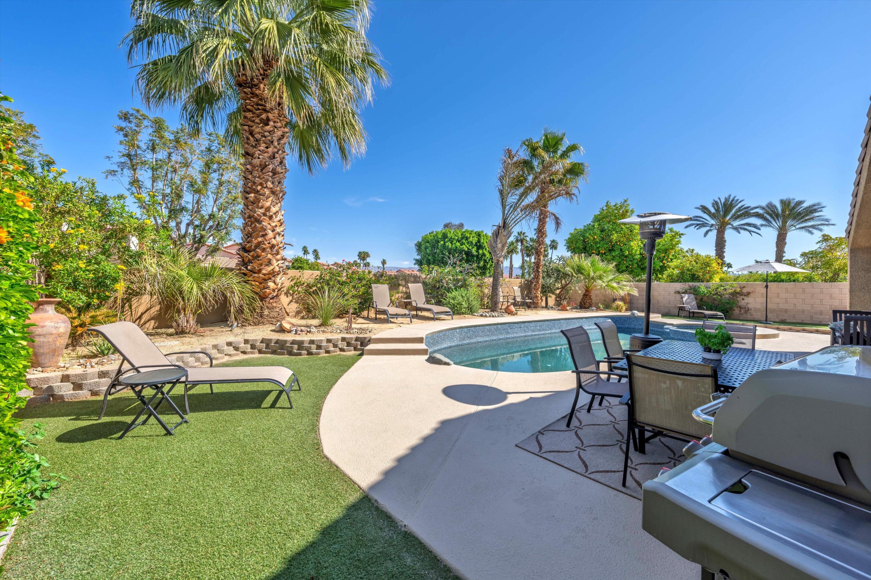 78330 Vía Sevilla La Quinta, CA 92253 - Photo 18 of 49 a swimming pool with outdoor seating and yard