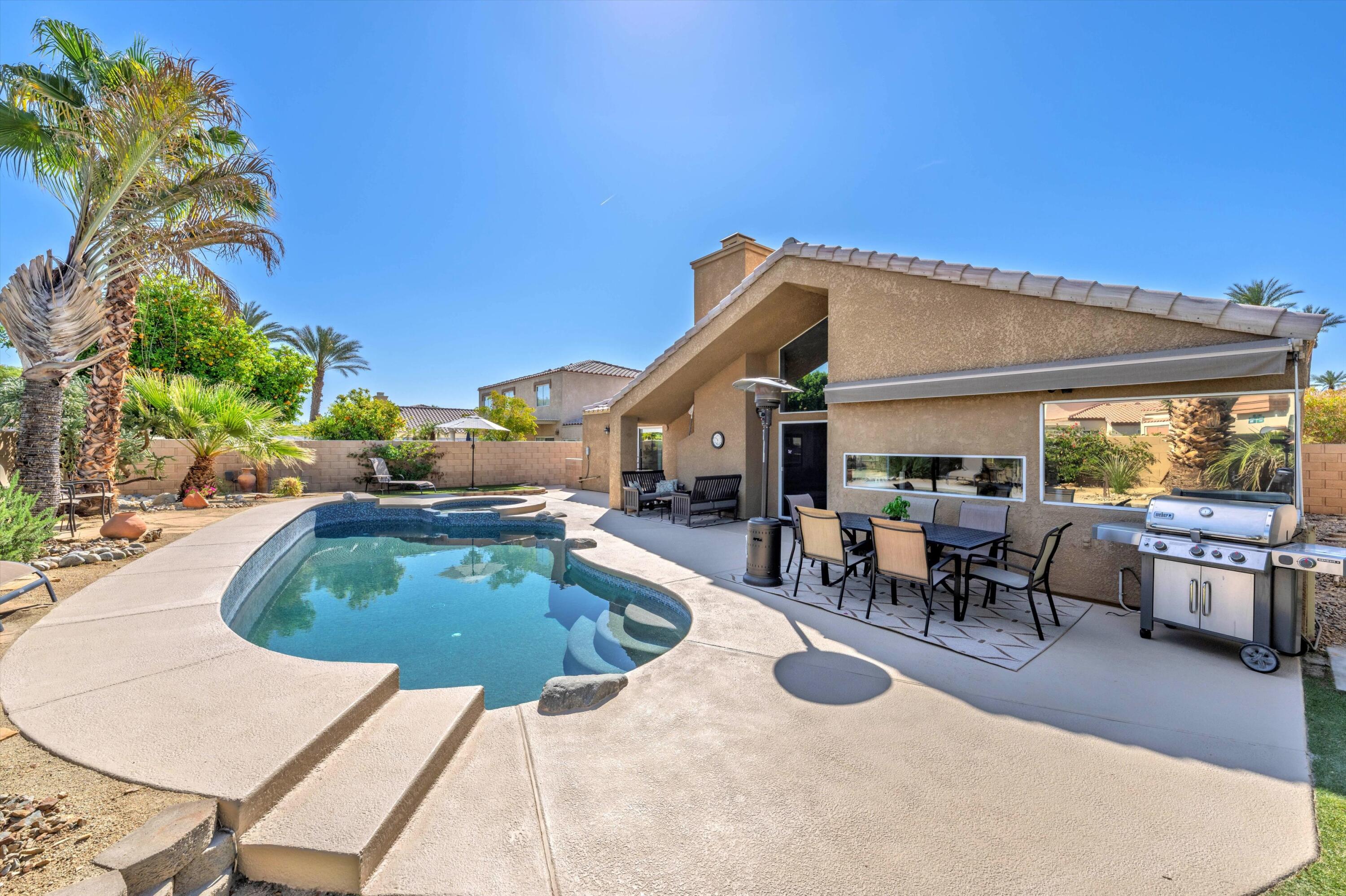 78330 Vía Sevilla La Quinta, CA 92253 - Photo 20 of 49 a swimming pool with outdoor seating and yard
