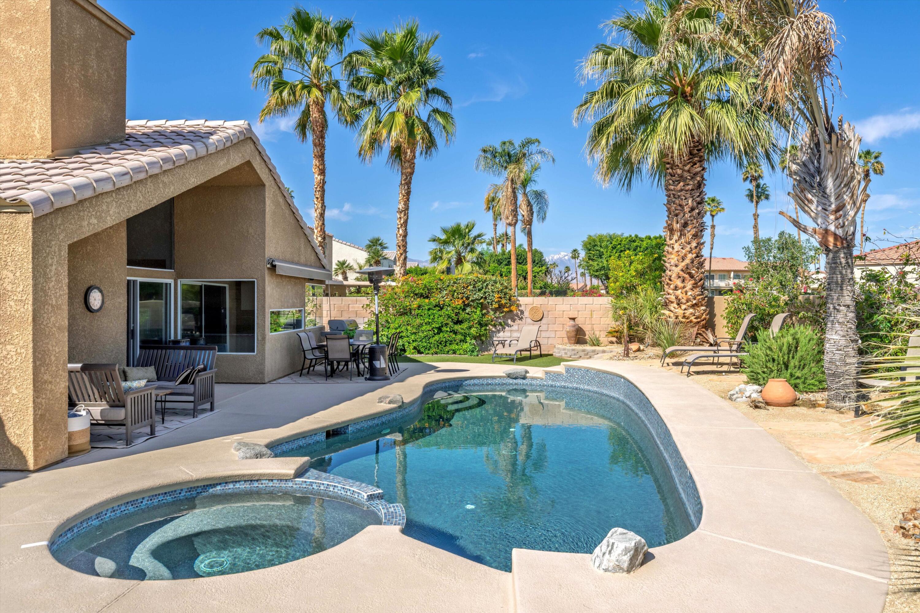 78330 Vía Sevilla La Quinta, CA 92253 - Photo 22 of 49 a swimming pool with outdoor seating and yard