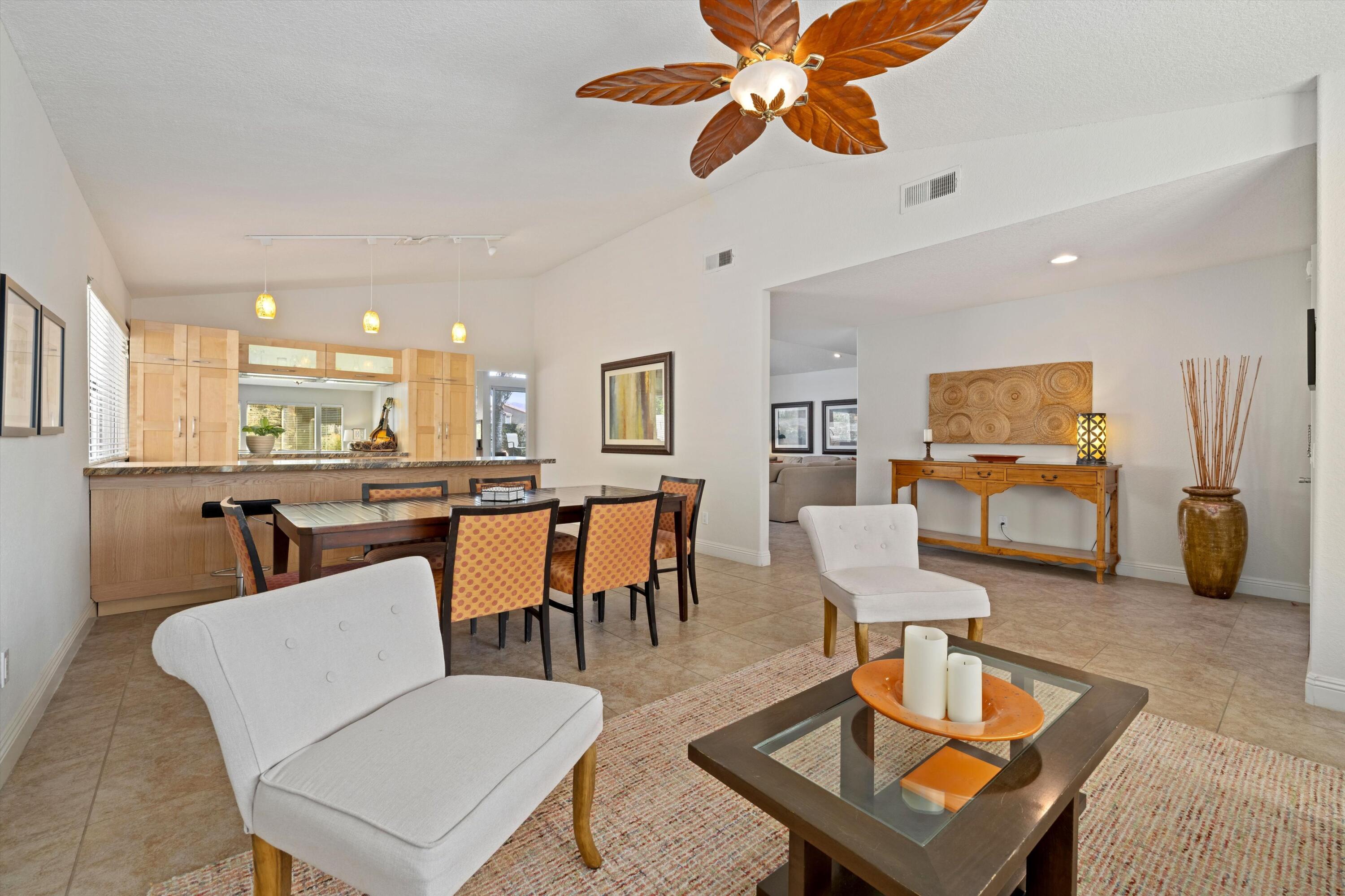 78330 Vía Sevilla La Quinta, CA 92253 - Photo 30 of 49 a living room with furniture kitchen view and a chandelier
