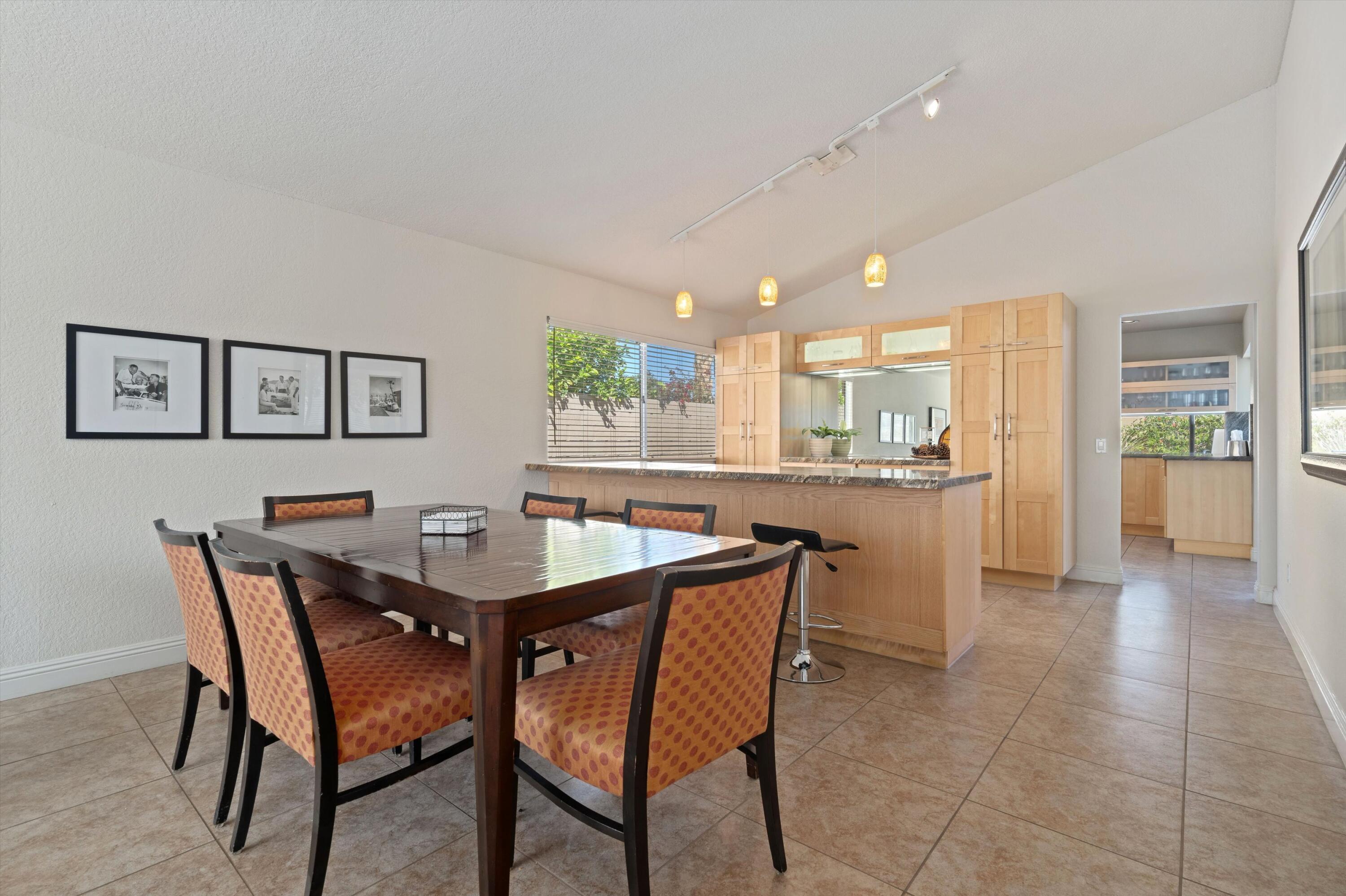 78330 Vía Sevilla La Quinta, CA 92253 - Photo 31 of 49 a view of a dining room with furniture and a kitchen