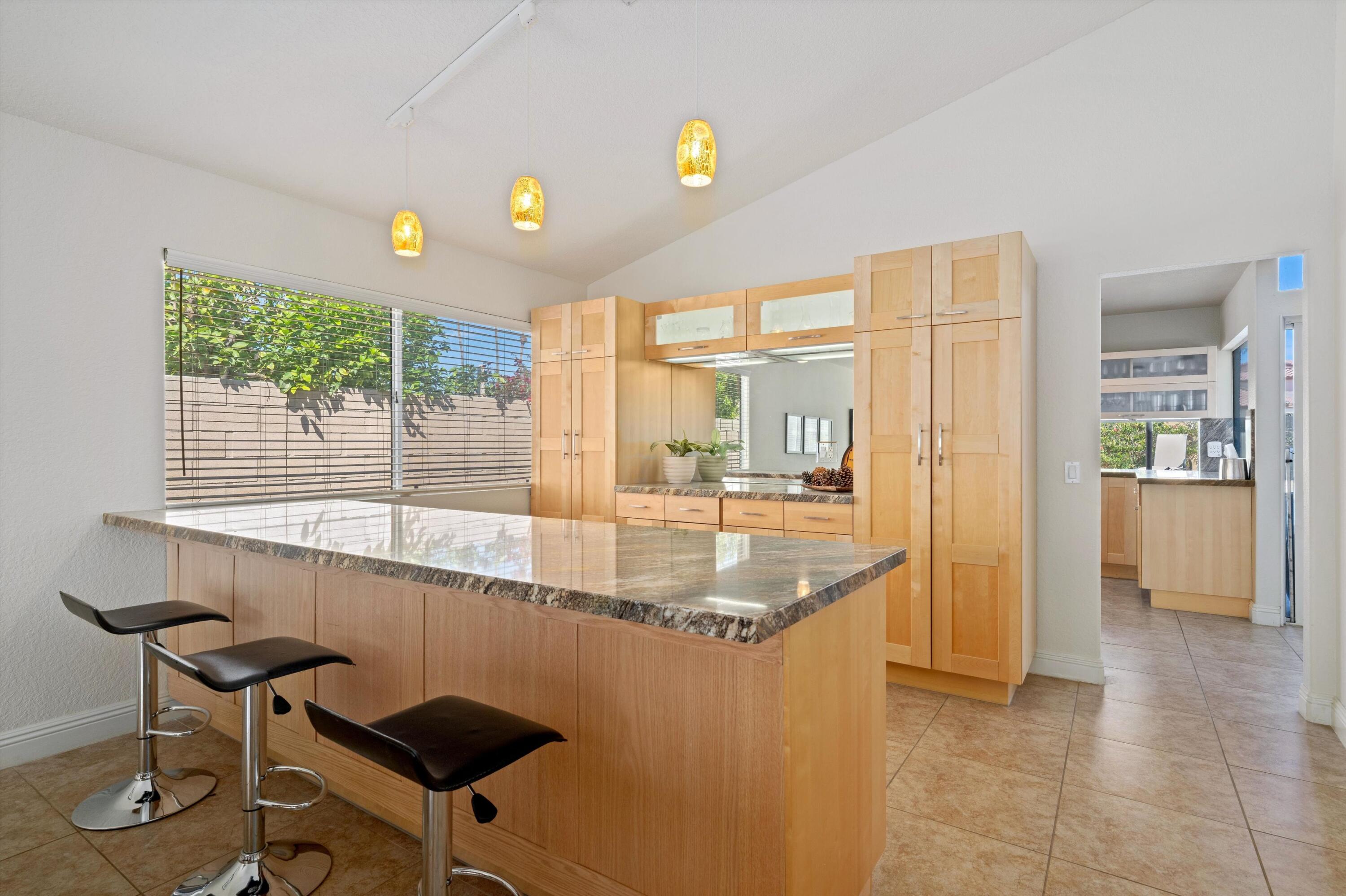 78330 Vía Sevilla La Quinta, CA 92253 - Photo 32 of 49 a kitchen with a sink and a large window
