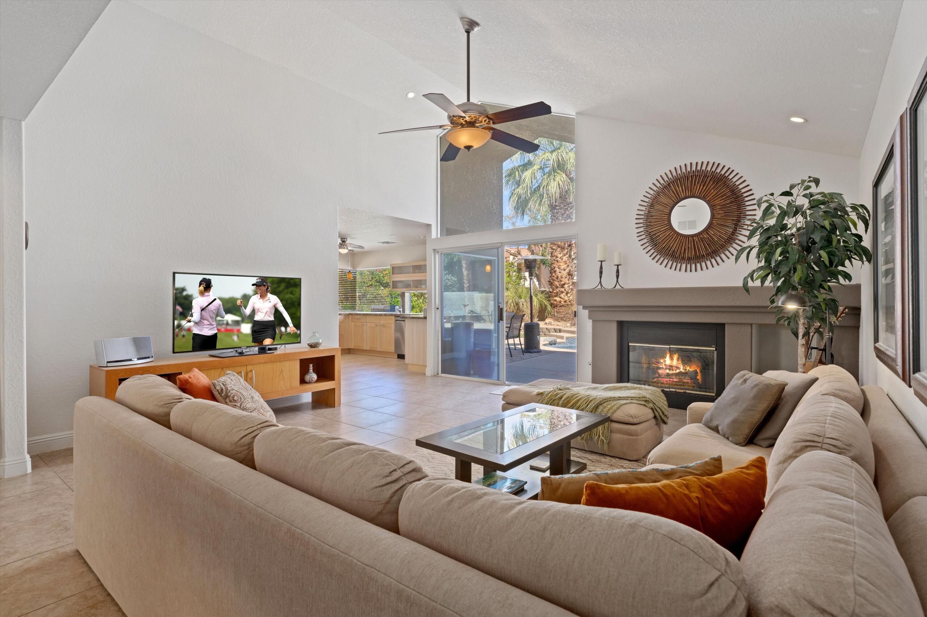 78330 Vía Sevilla La Quinta, CA 92253 - Photo 35 of 49 a living room with furniture a fireplace and a chandelier