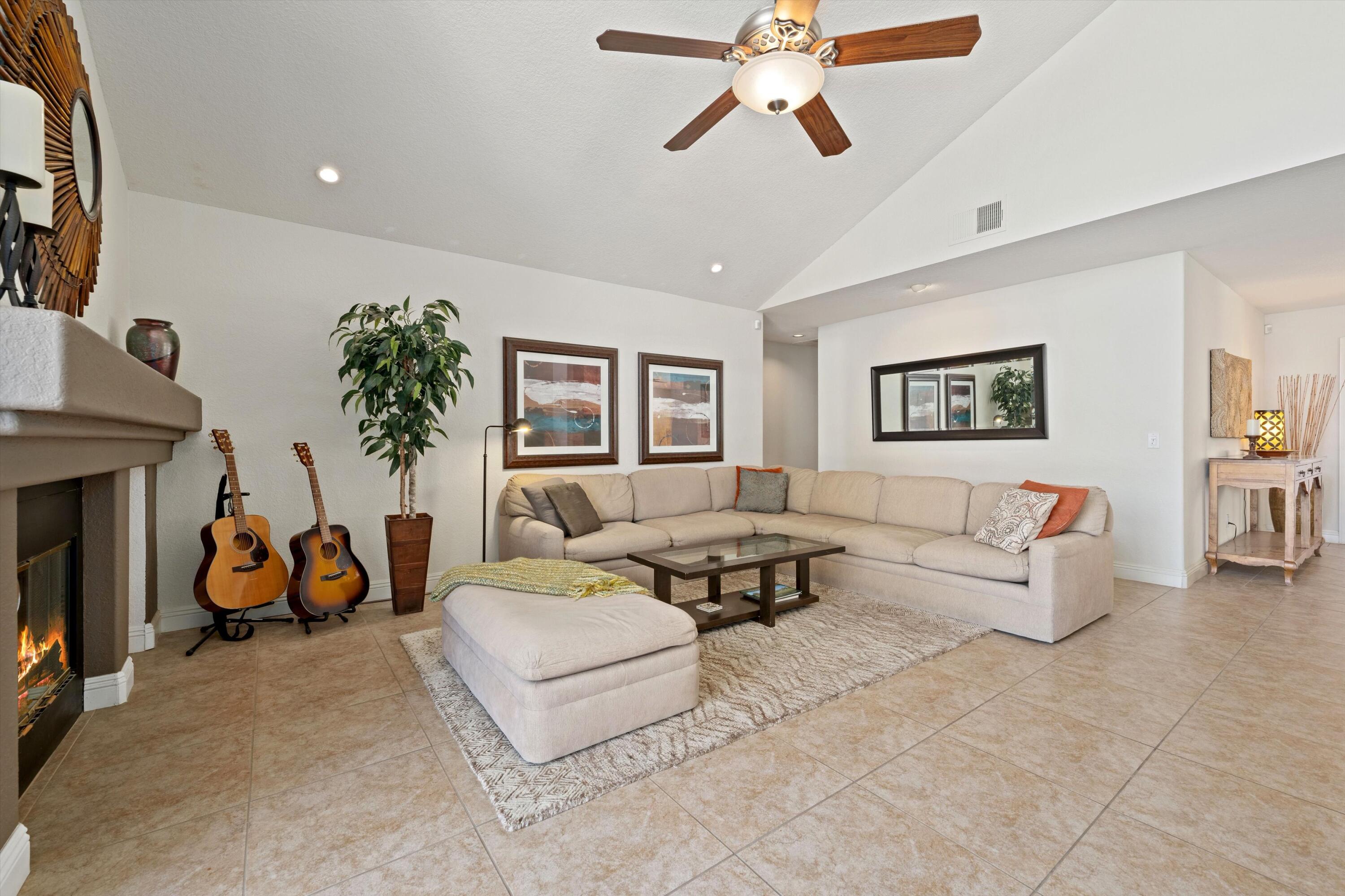 78330 Vía Sevilla La Quinta, CA 92253 - Photo 36 of 49 a living room with furniture and a fireplace