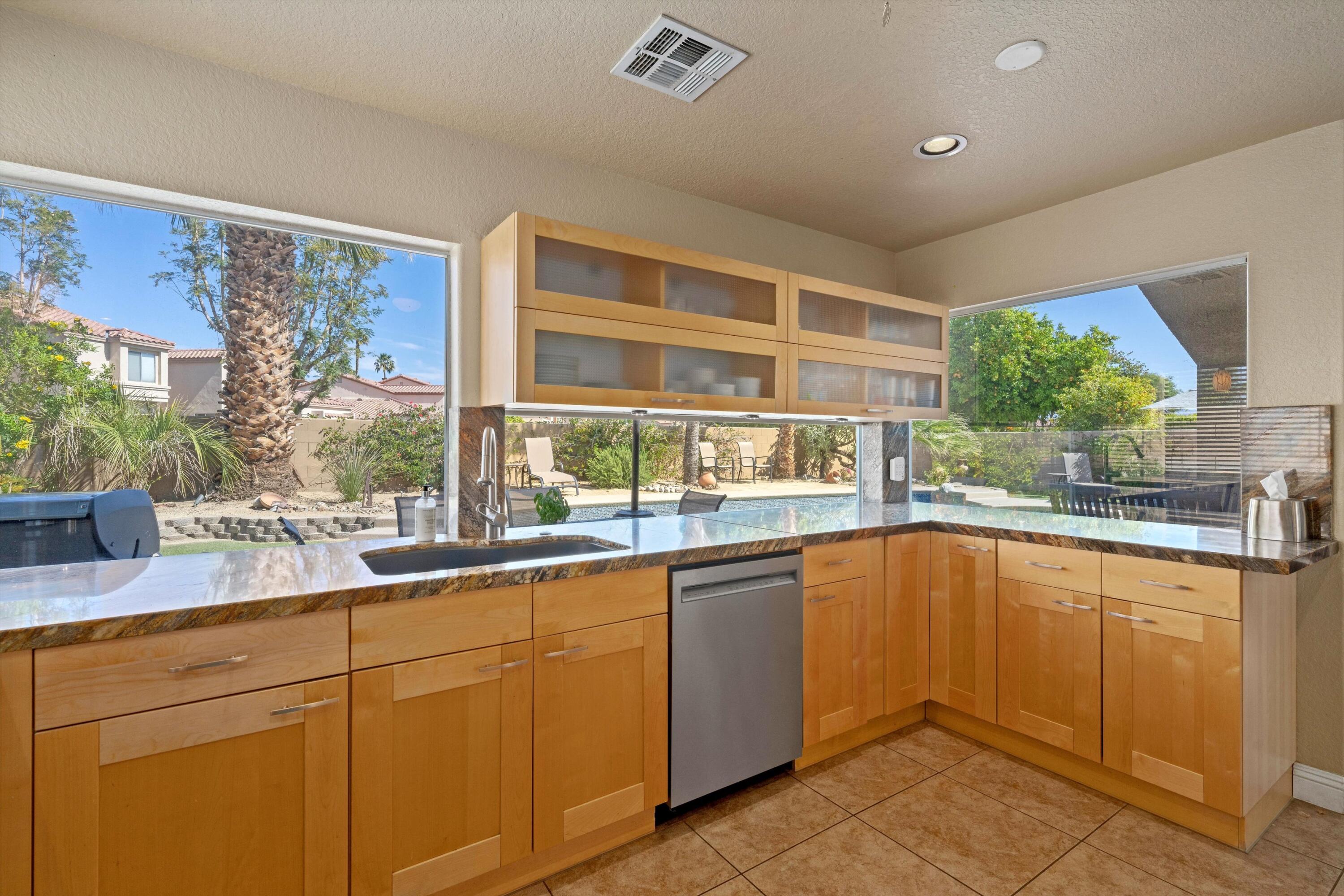 78330 Vía Sevilla La Quinta, CA 92253 - Photo 39 of 49 a kitchen with a sink and large window