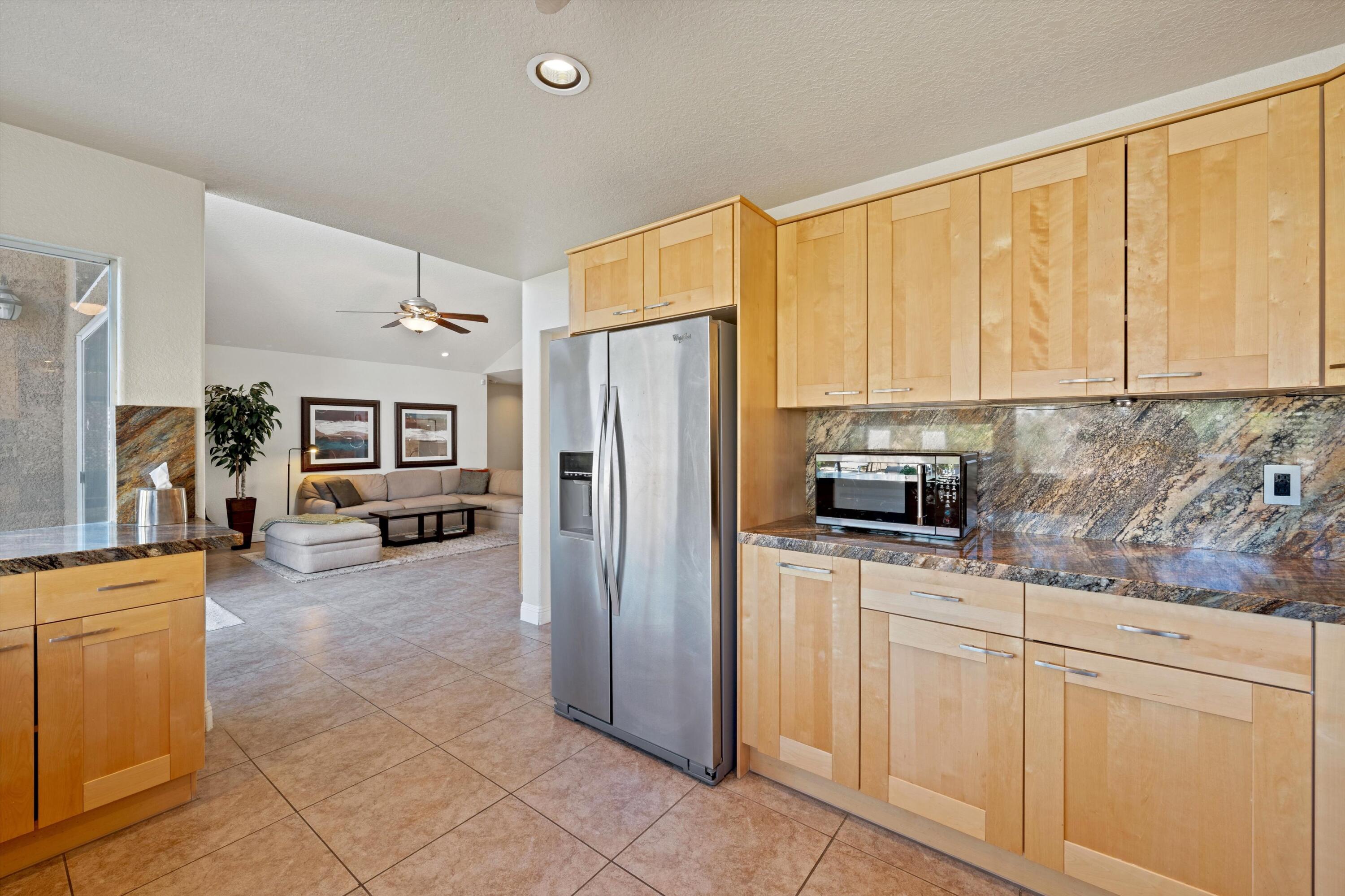 78330 Vía Sevilla La Quinta, CA 92253 - Photo 40 of 49 a kitchen with stainless steel appliances a refrigerator sink and cabinets