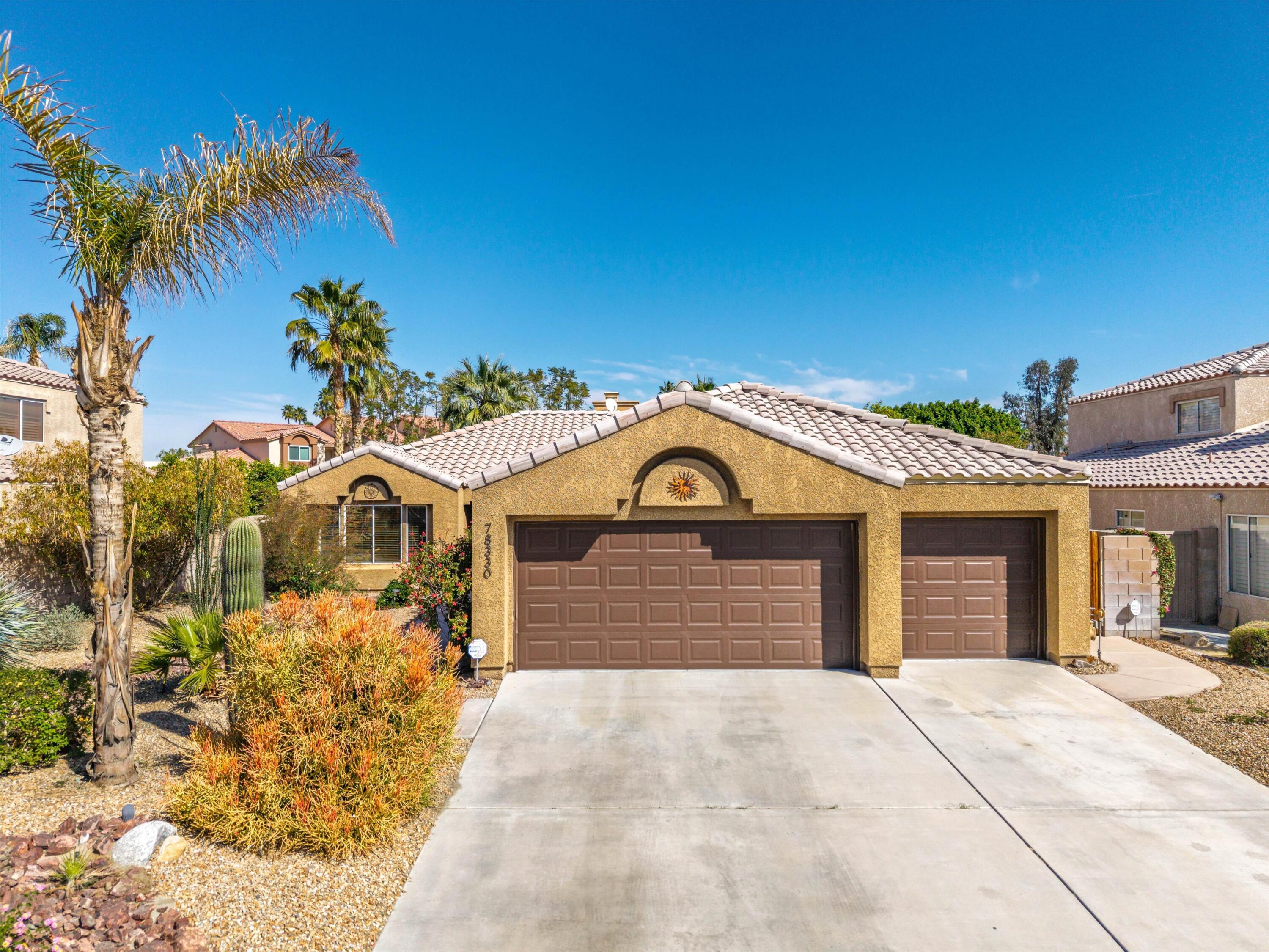 78330 Vía Sevilla La Quinta, CA 92253 - Photo 4 of 49 a front view of a house with a yard