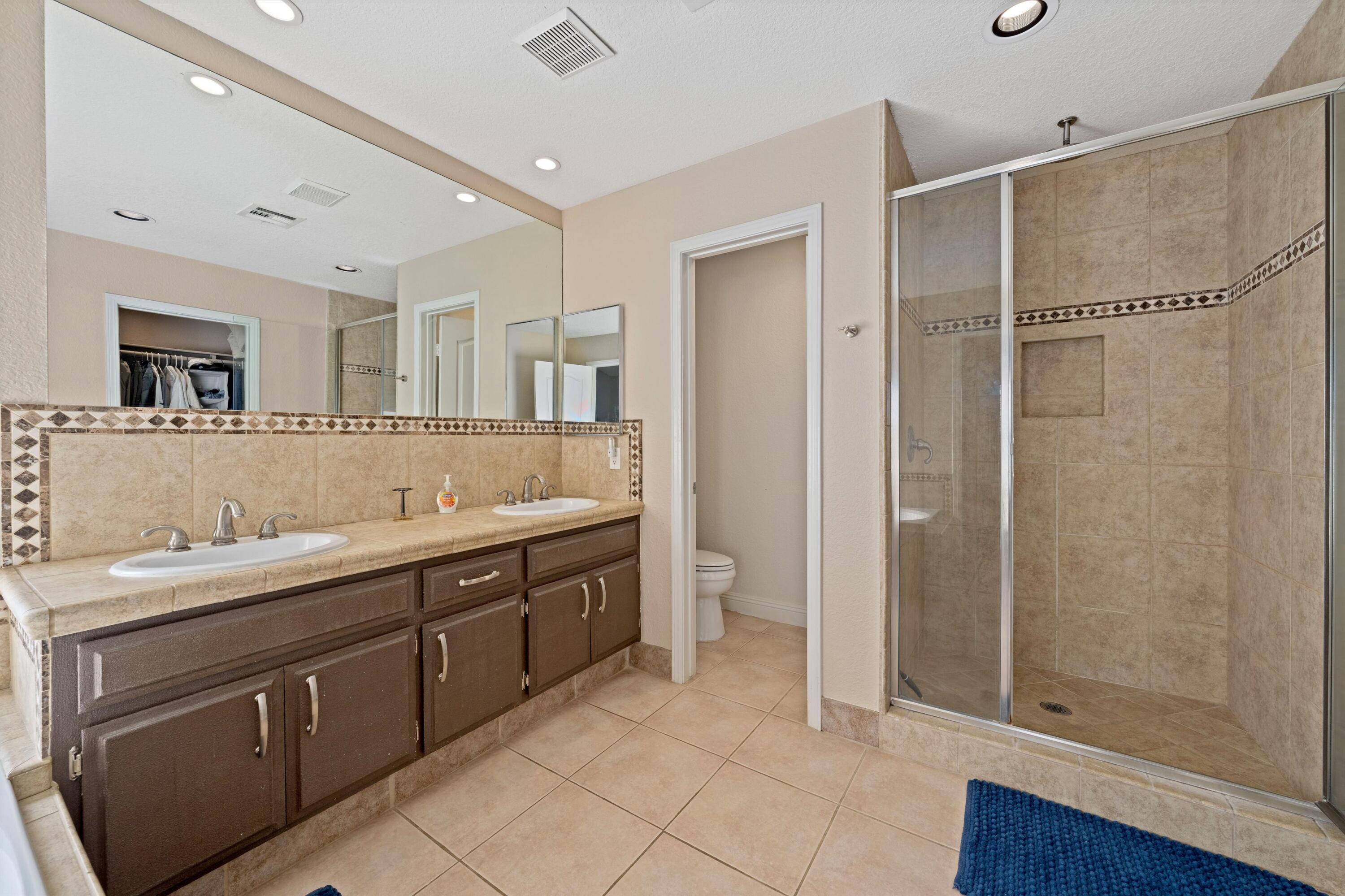 78330 Vía Sevilla La Quinta, CA 92253 - Photo 43 of 49 a spacious bathroom with a shower sink and mirror