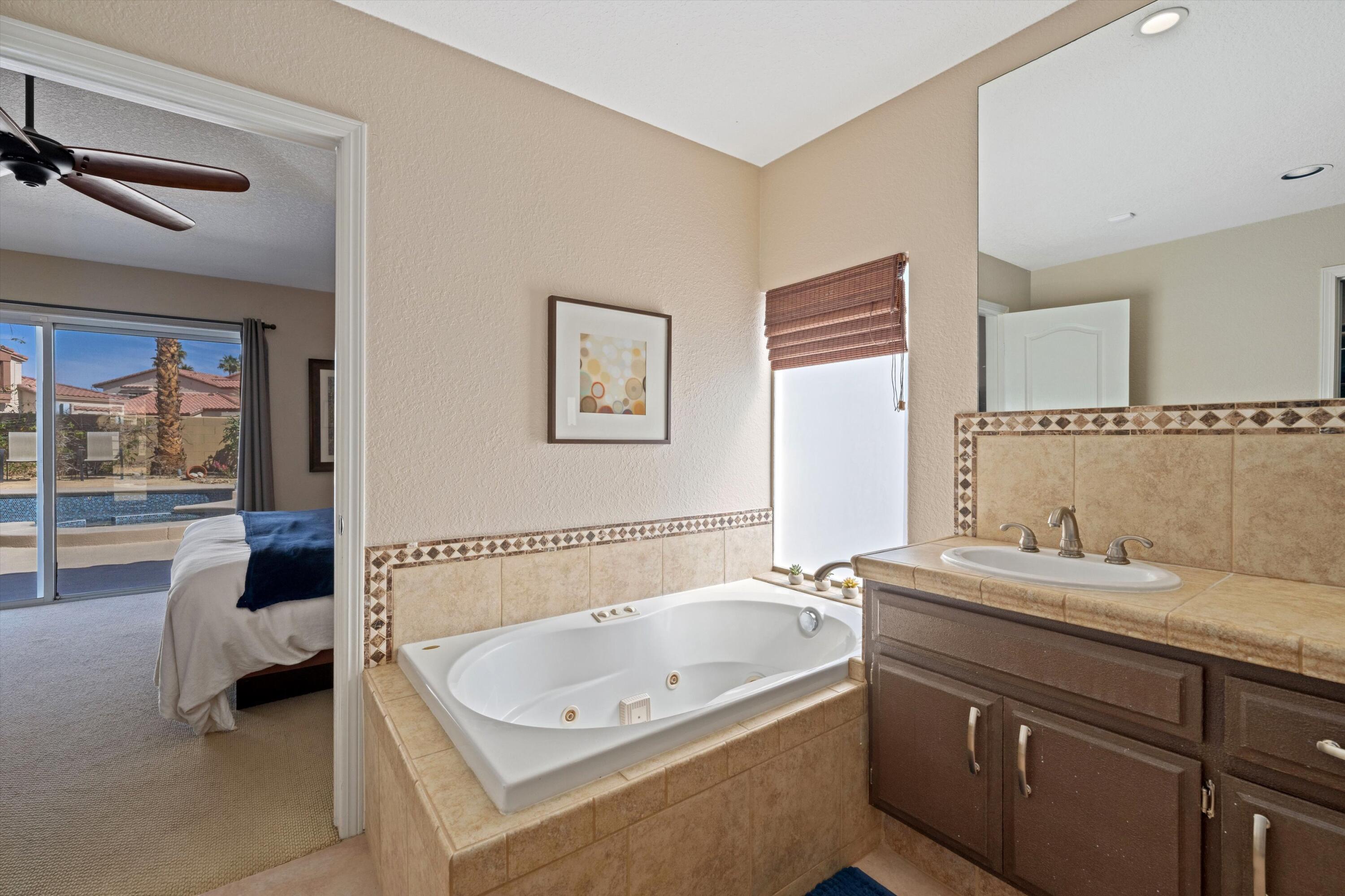 78330 Vía Sevilla La Quinta, CA 92253 - Photo 44 of 49 a bathroom with a tub a double vanity sink and mirror