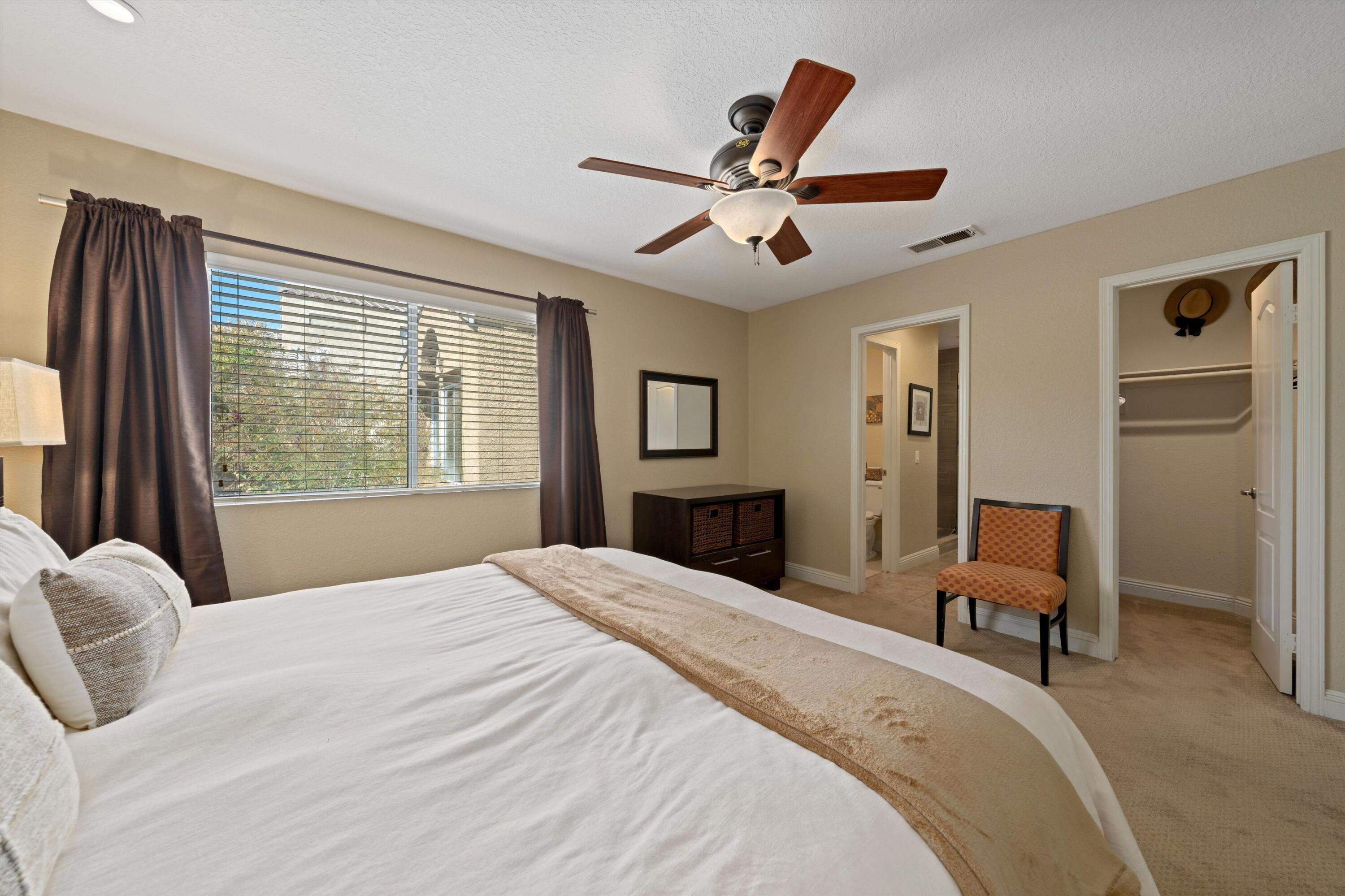 78330 Vía Sevilla La Quinta, CA 92253 - Photo 46 of 49 a bedroom with a large bed and a window