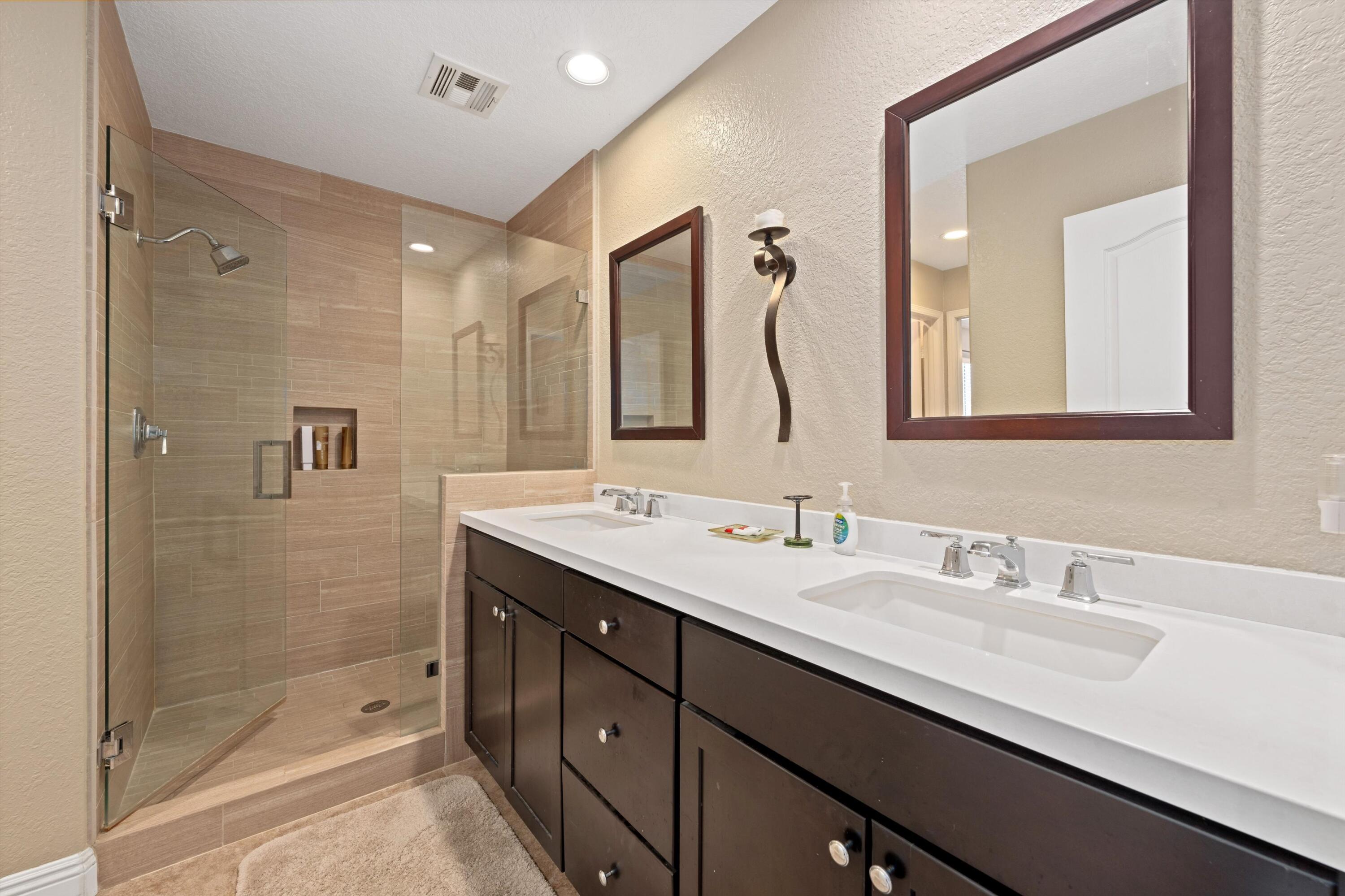 78330 Vía Sevilla La Quinta, CA 92253 - Photo 47 of 49 a bathroom with a double vanity sink mirror and shower