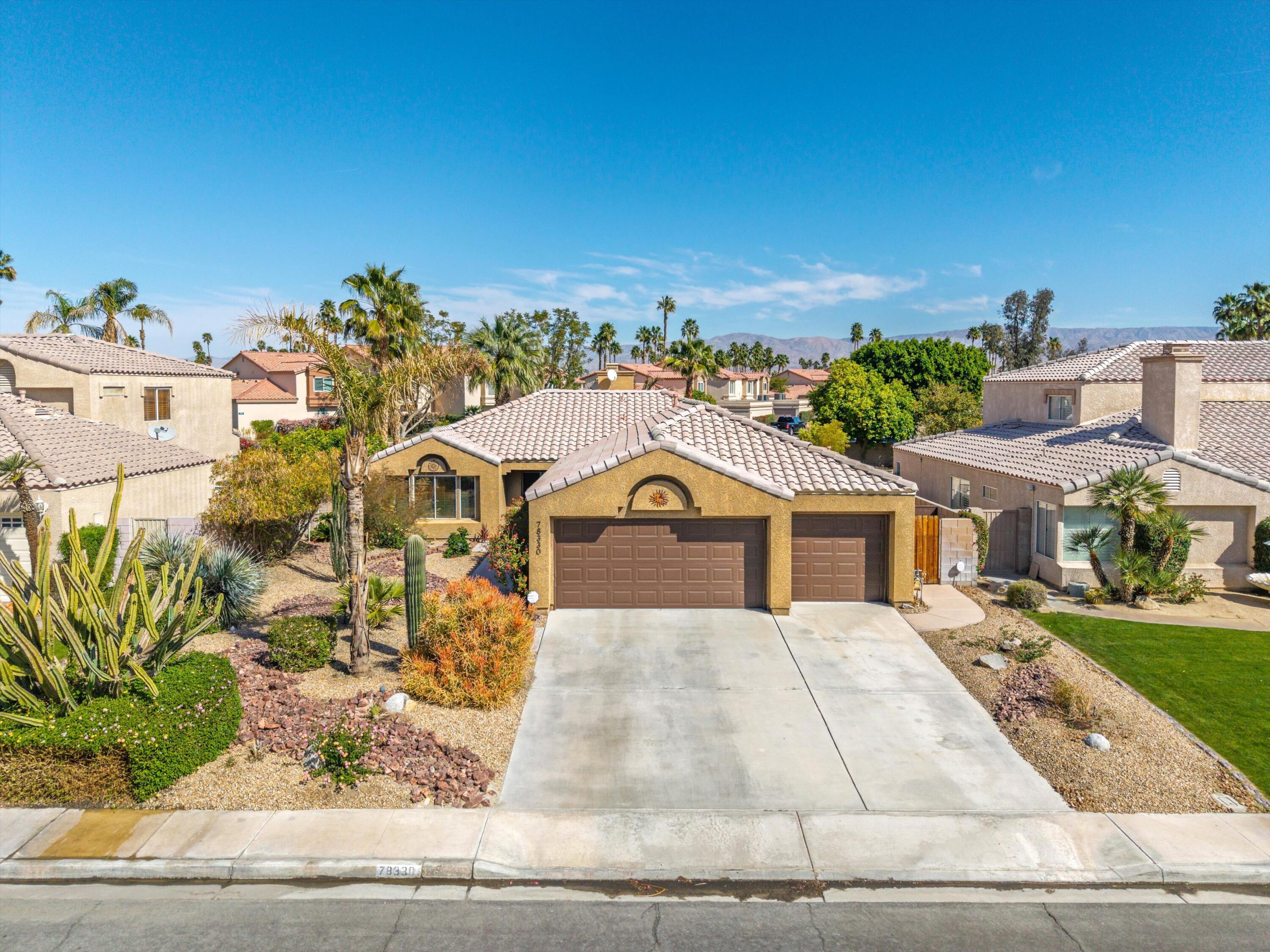 78330 Vía Sevilla La Quinta, CA 92253 - Photo 5 of 49 front view of a house with a yard