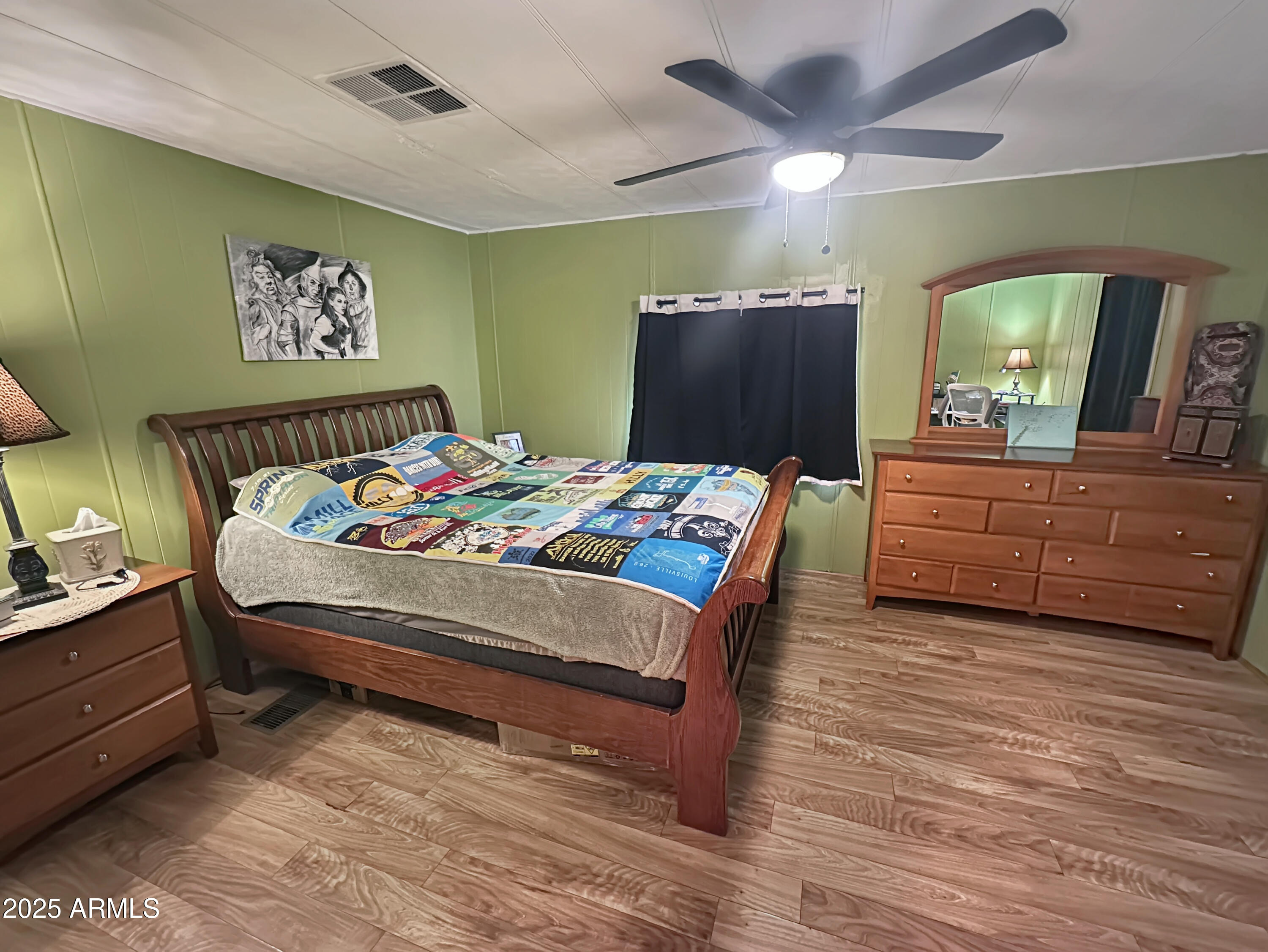201 South Greenfield Road, Unit 18 Mesa, AZ 85206 - Photo 13 of 17 a bedroom with a bed and a chandelier