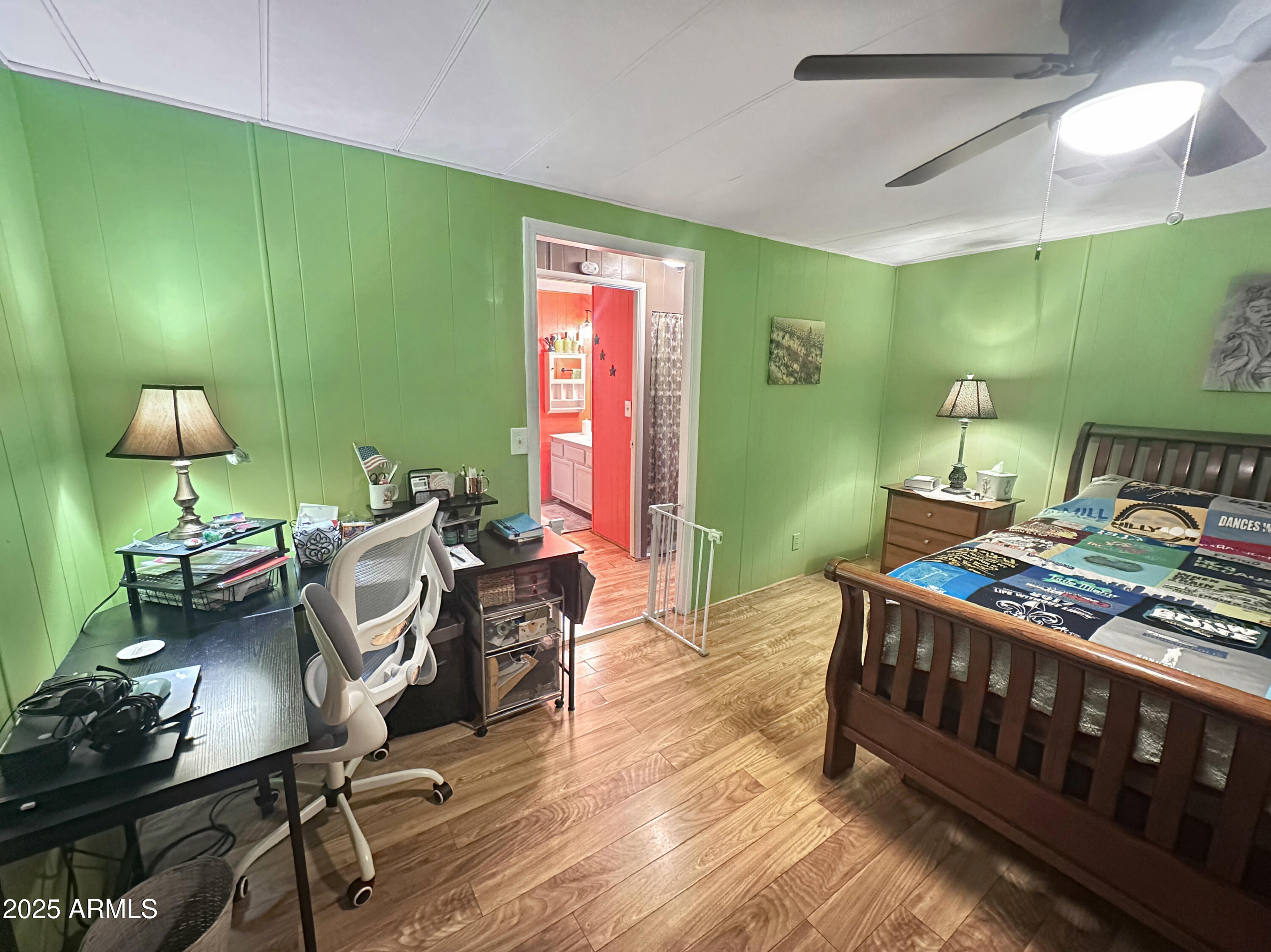 201 South Greenfield Road, Unit 18 Mesa, AZ 85206 - Photo 14 of 17 a bedroom with furniture and a wooden floor