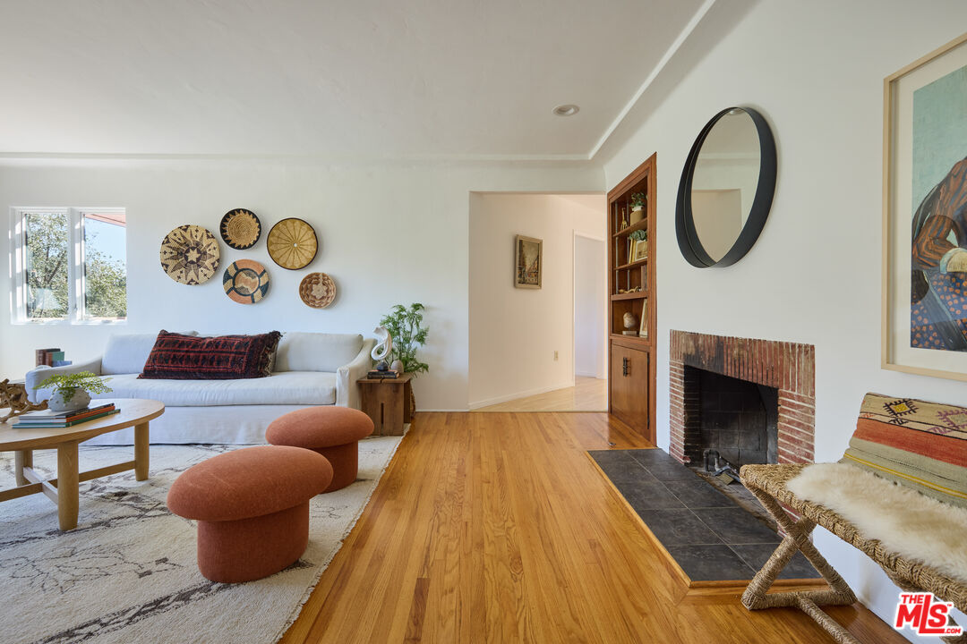 6948 St Estaban Street Tujunga, CA 91042 - Photo 18 of 26 a living room with furniture and a fireplace
